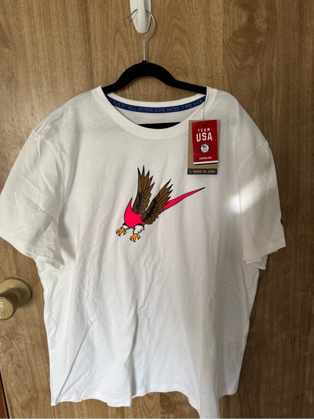 Nike White Short Sleeve T-Shirt with Pink & Brown Eagle Graphic